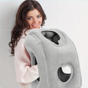 Woman hugging the grey inflatable travel pillow