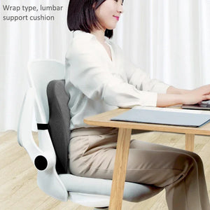Woman at desk sitting with lumbar support cushion