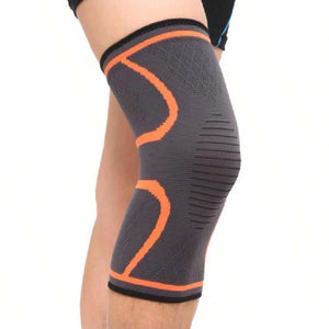 Orange knit knee compression sleeve worn on the knee