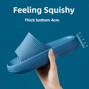Hand squeezing a blue cloud slipper to show 4 cm soft sole