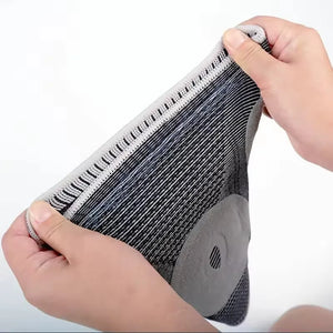 Hands stretching the knit knee sleeve to show elasticity