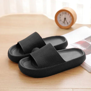 Black cloud slippers on a table